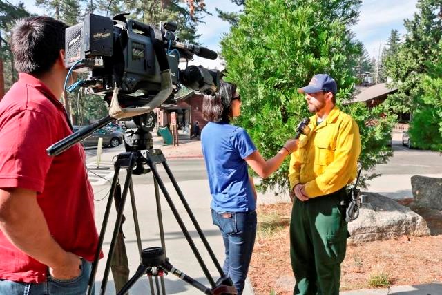 Fire information officer gives an interview. A fire information officer gives an interview.