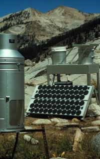 A solar powered, aerochemetric rain sampler and rain gauge collect precipitation and dry atmospheric deposition data at Emerald Lake in Sequoia National Park. A solar powered, aerochemetric rain sampler and rain gauge collect precipitation and dry atmospheric deposition data at Emerald Lake in Sequoia National Park.