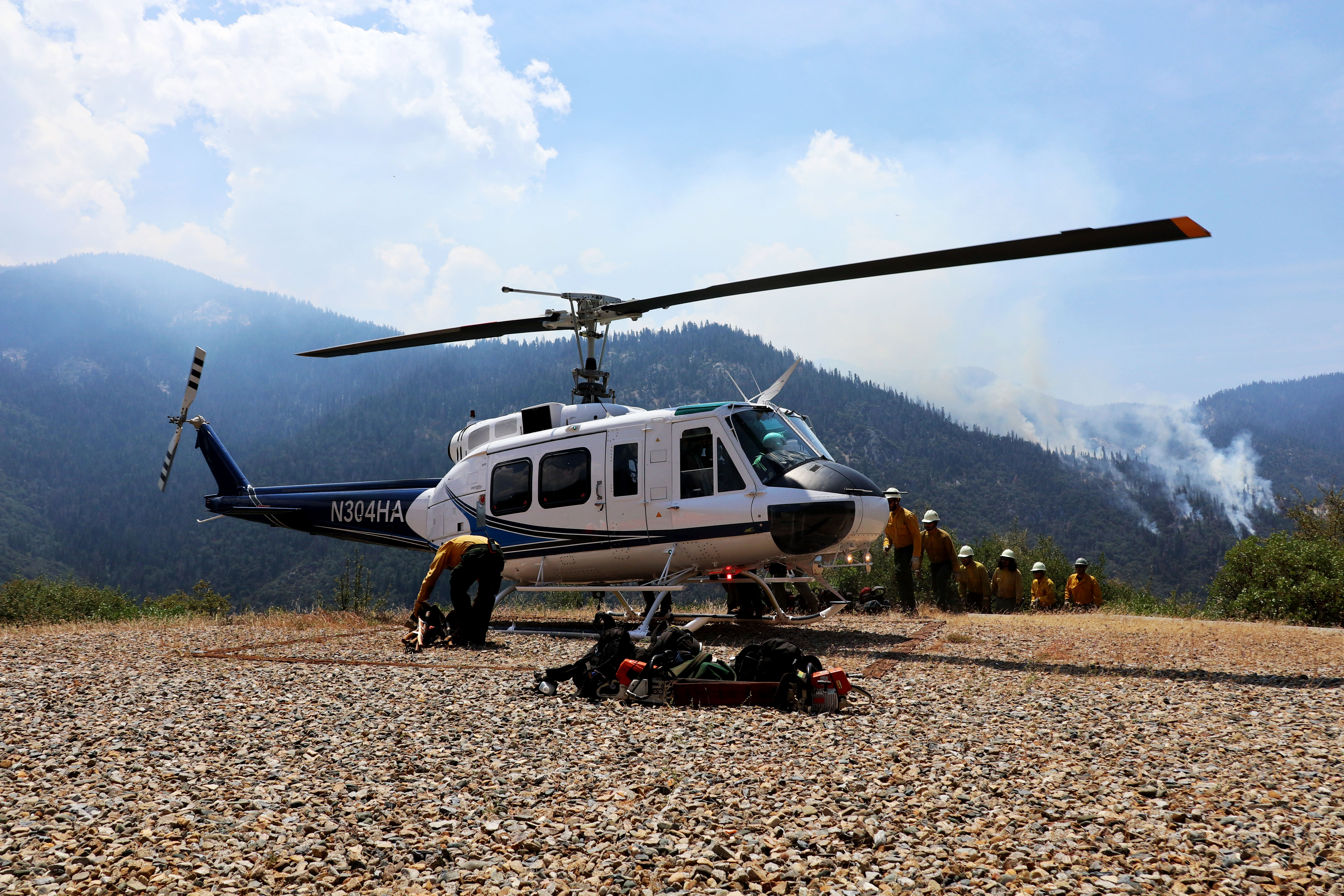 A fire crew lines-up prior to boarding a helicopter