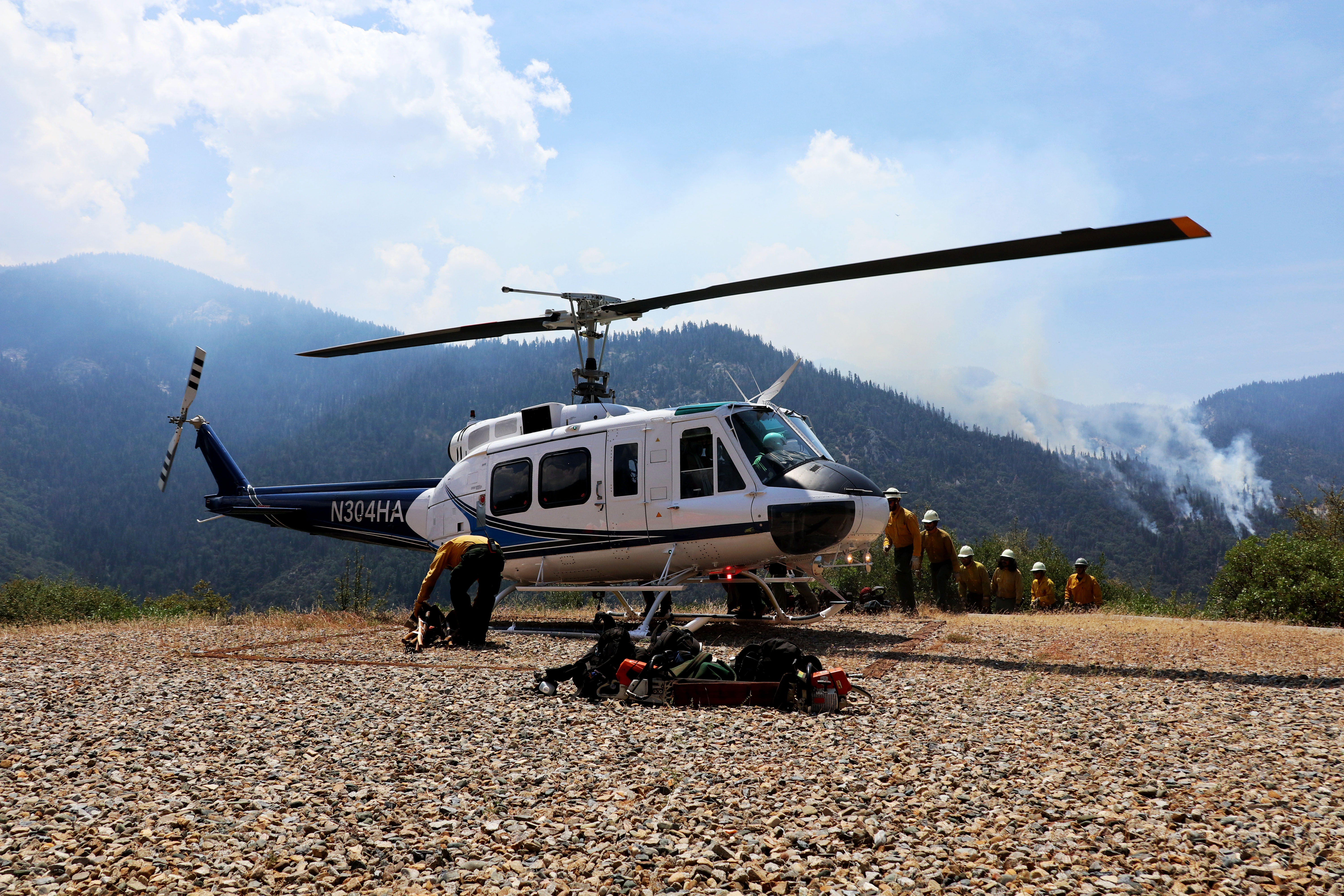 A fire crew lines-up prior to boarding a helicopter A fire crew lines-up prior to boarding a helicopter