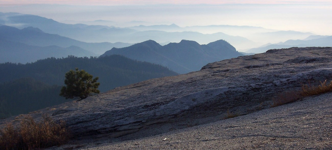 A view of hazy maountain ranges from atop Little Baldy