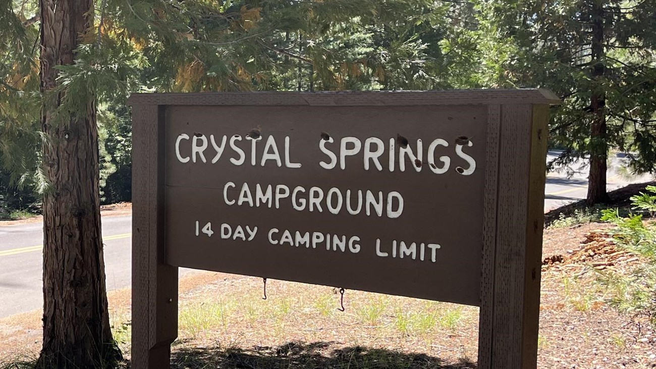 Brown sign with the words "Crystal Springs Campground, 14 day camping limit."