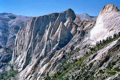 Rounded granite cliffs rise above an alpine landscape. Rounded granite cliffs rise above an alpine landscape.
