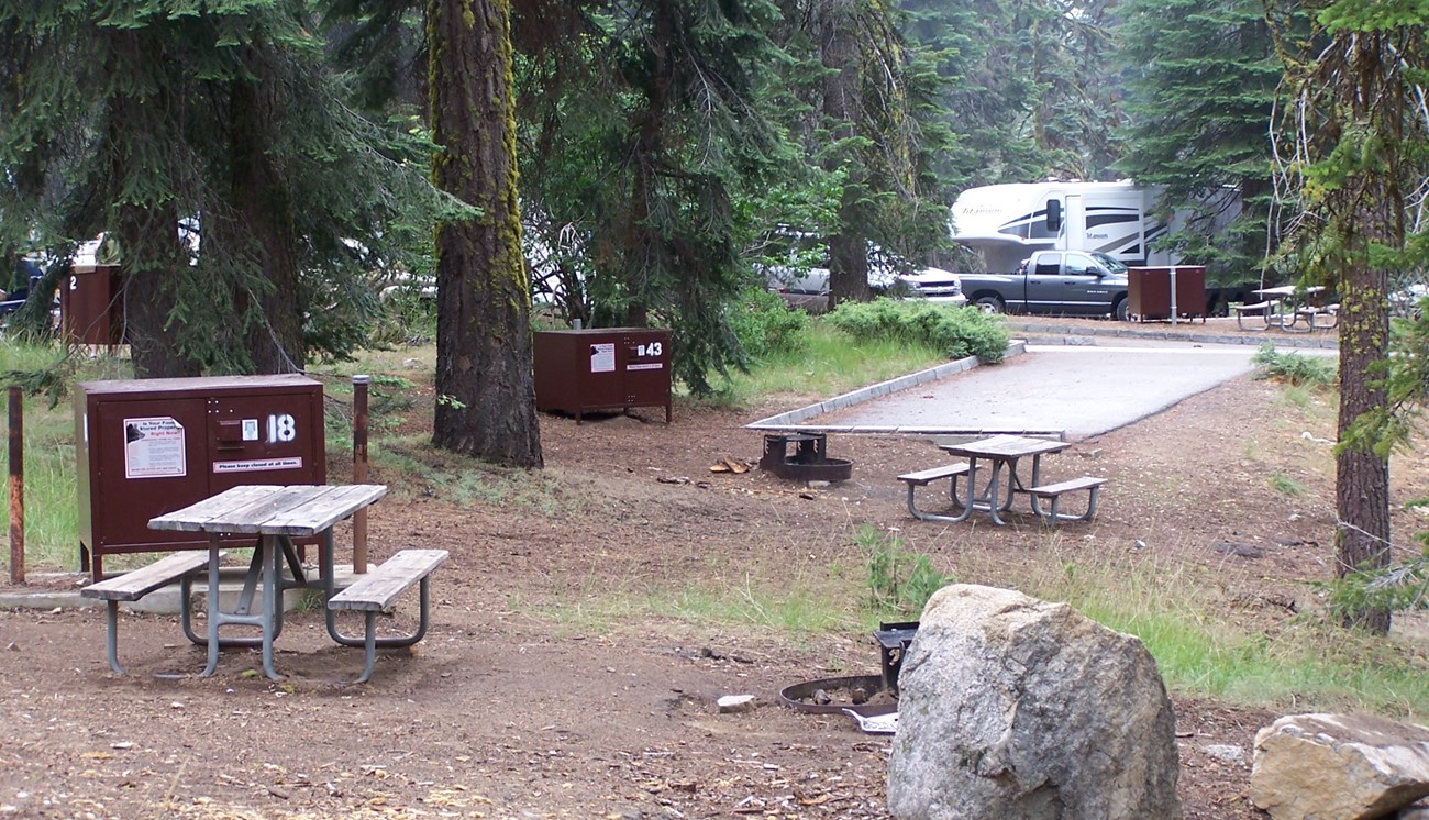 Dorst Creek Campground sites with food storage boxes, and RV and trailer in background.