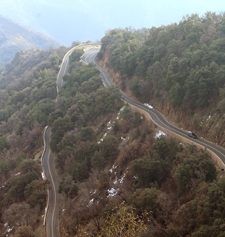 A truck drives on a mountain road