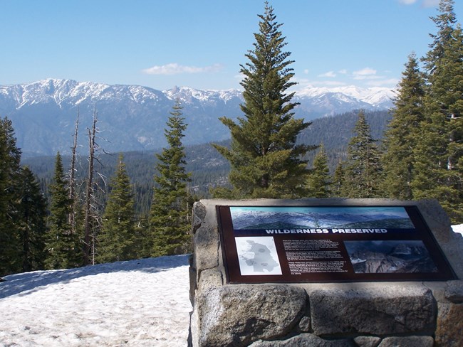 A sign set in a stone base at a scenic overlook