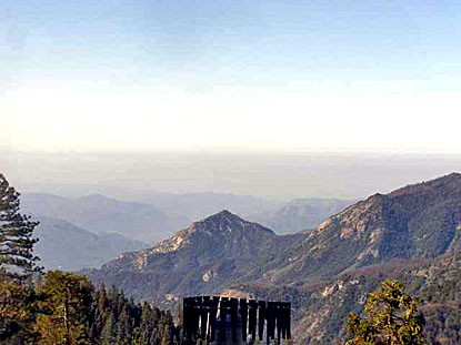 Layers of polluted air hang over the valley beyond a ridge of hills. Layers of polluted air hang over the valley beyond a ridge of hills.