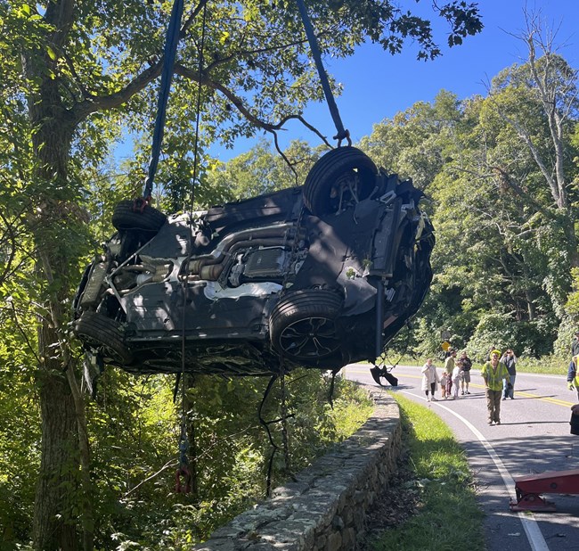 Totaled vehicle removed from behind rock wall on Skyline Drive Totaled vehicle removed from behind rock wall on Skyline Drive