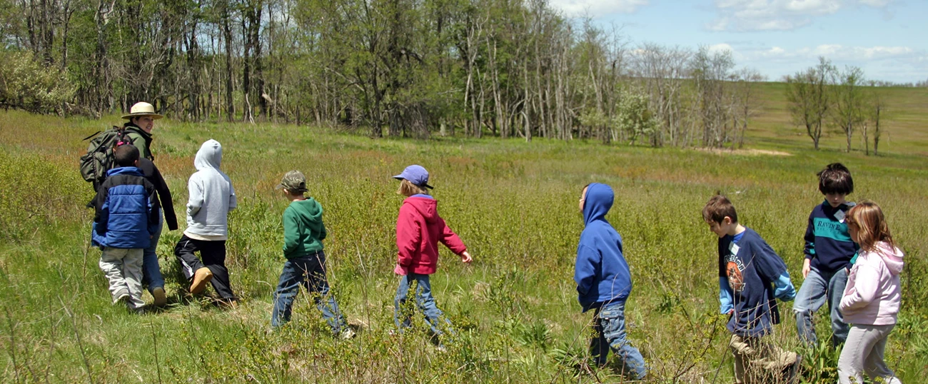 Education group in Big Meadows A Ranger leading a group of students through a meadow.