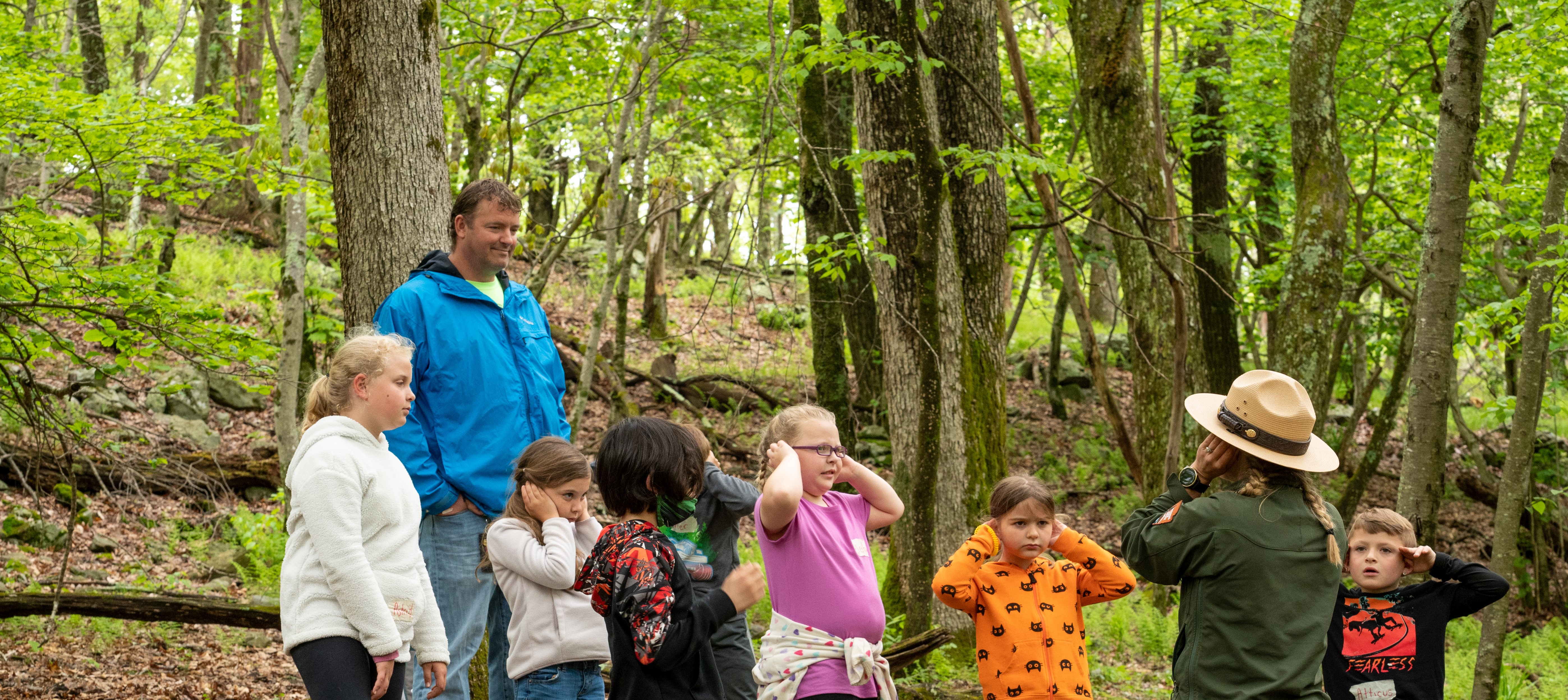 Education Ranger teaching a listening activity in the forest