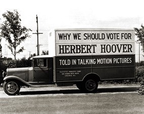 A truck displaying the message "Why we should vote for Herbert Hoover."