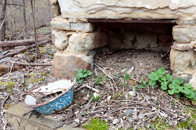 A colored ceramic bowl on a chimney.