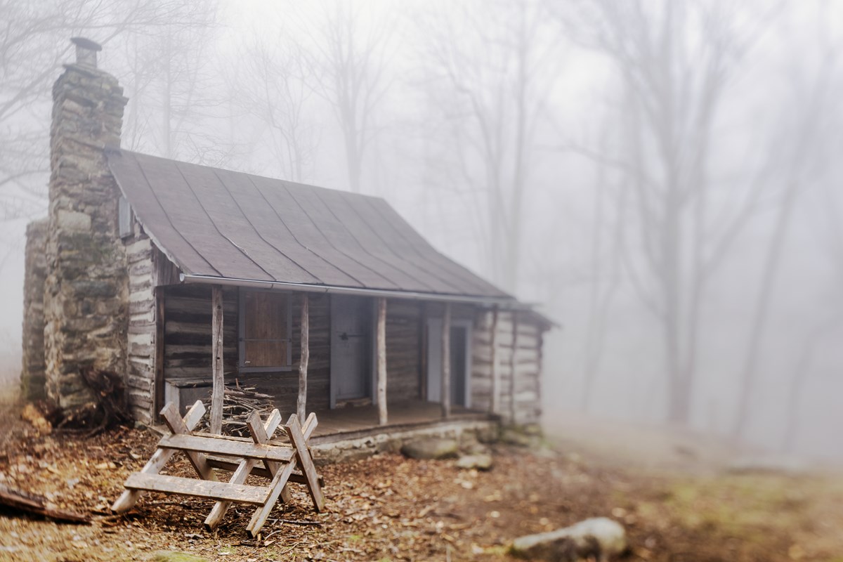 A historic cabin in the fog.