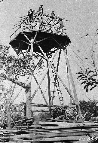 Historic black & white photo of Civilian Conservation enrollees constructing a fire tower. Historic black & white photo of Civilian Conservation enrollees constructing a fire tower.