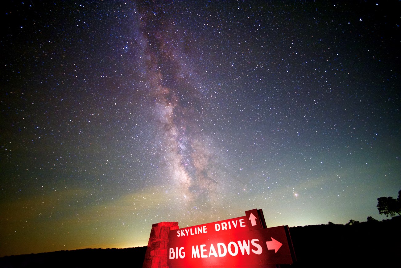 The Milky Way Galaxy cuts across the night sky above the Skyline Drive, Big Meadows sign