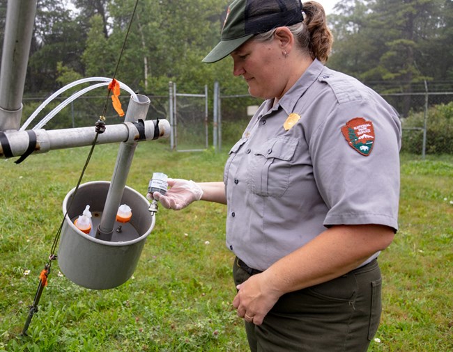 A park scientist works with air quality sampling equipment.