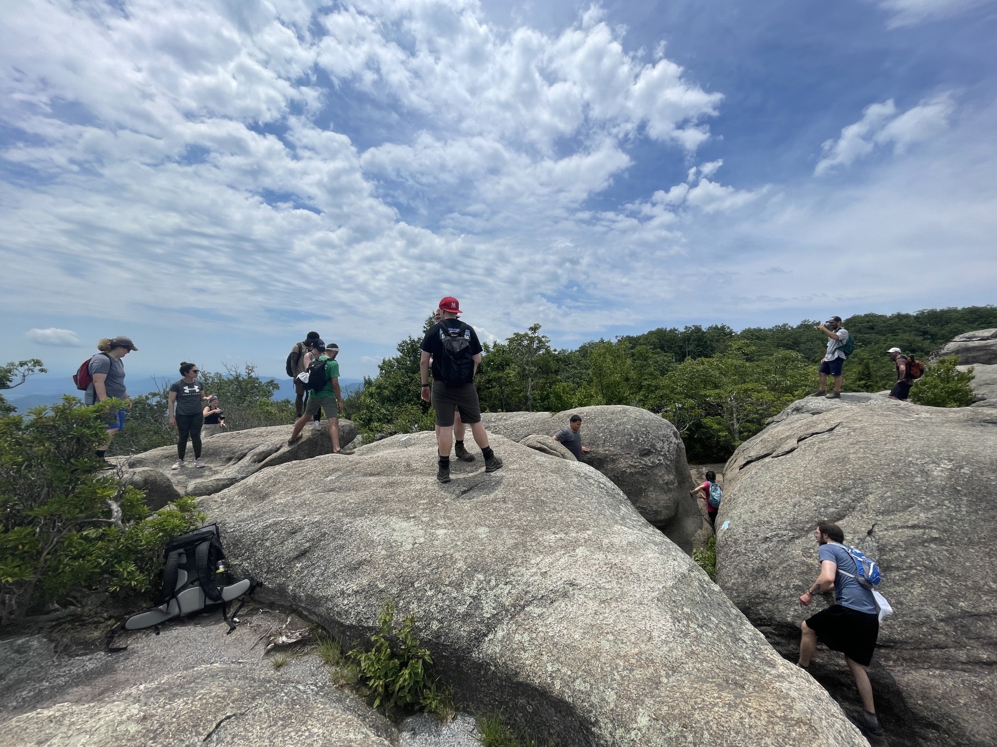A crowd of hikers navigating a rock scramble on Old Rag.