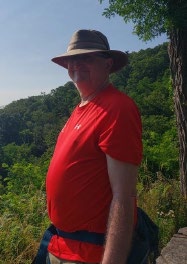 Mr. Bieri wearing a red shirt, hat and fanny pack Mr. Bieri wearing a red shirt, hat and fanny pack