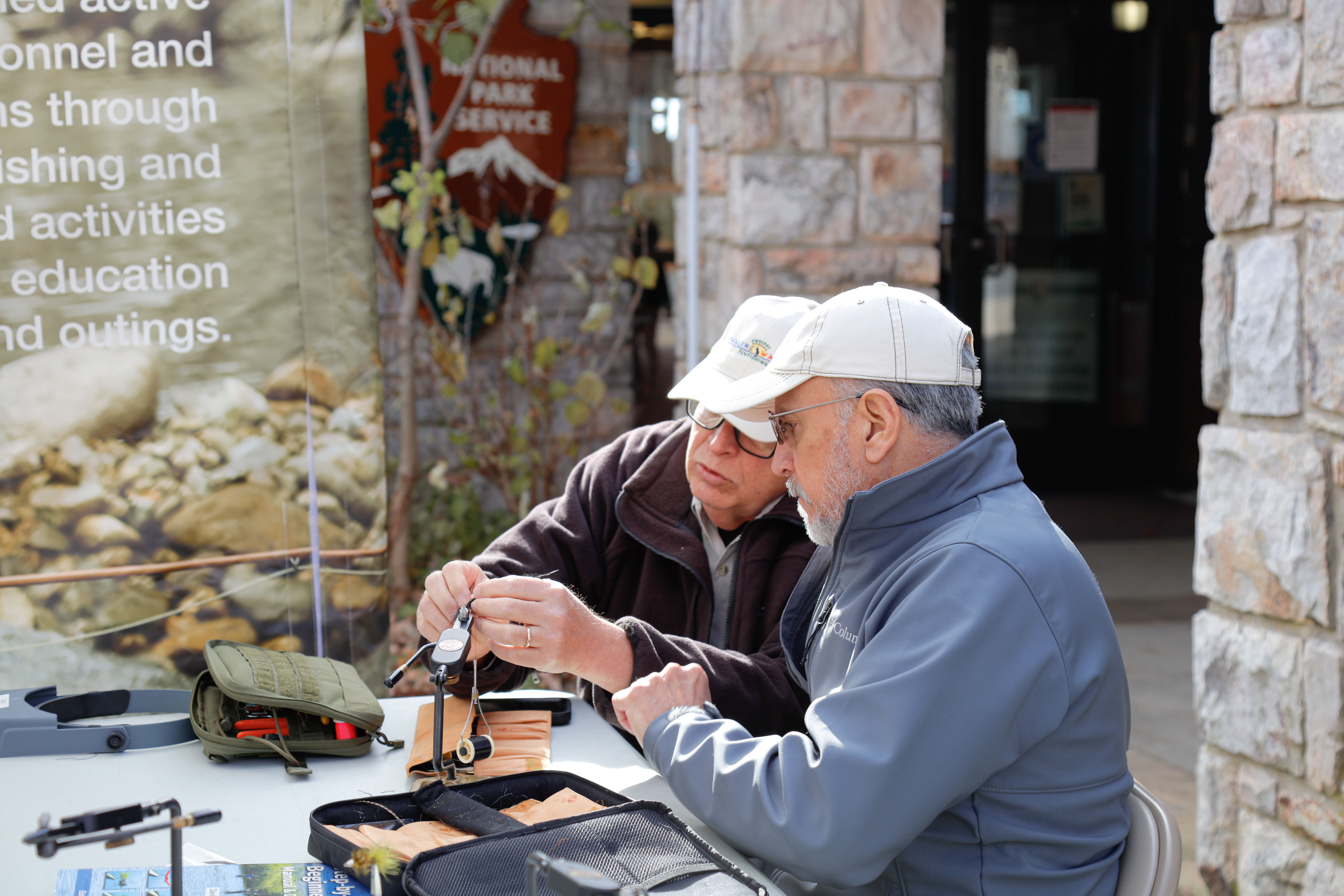 Two men at a fly-tying workshop at Byrd Visitor Center in 2021 Two men at a fly-tying workshop at Byrd Visitor Center in 2021