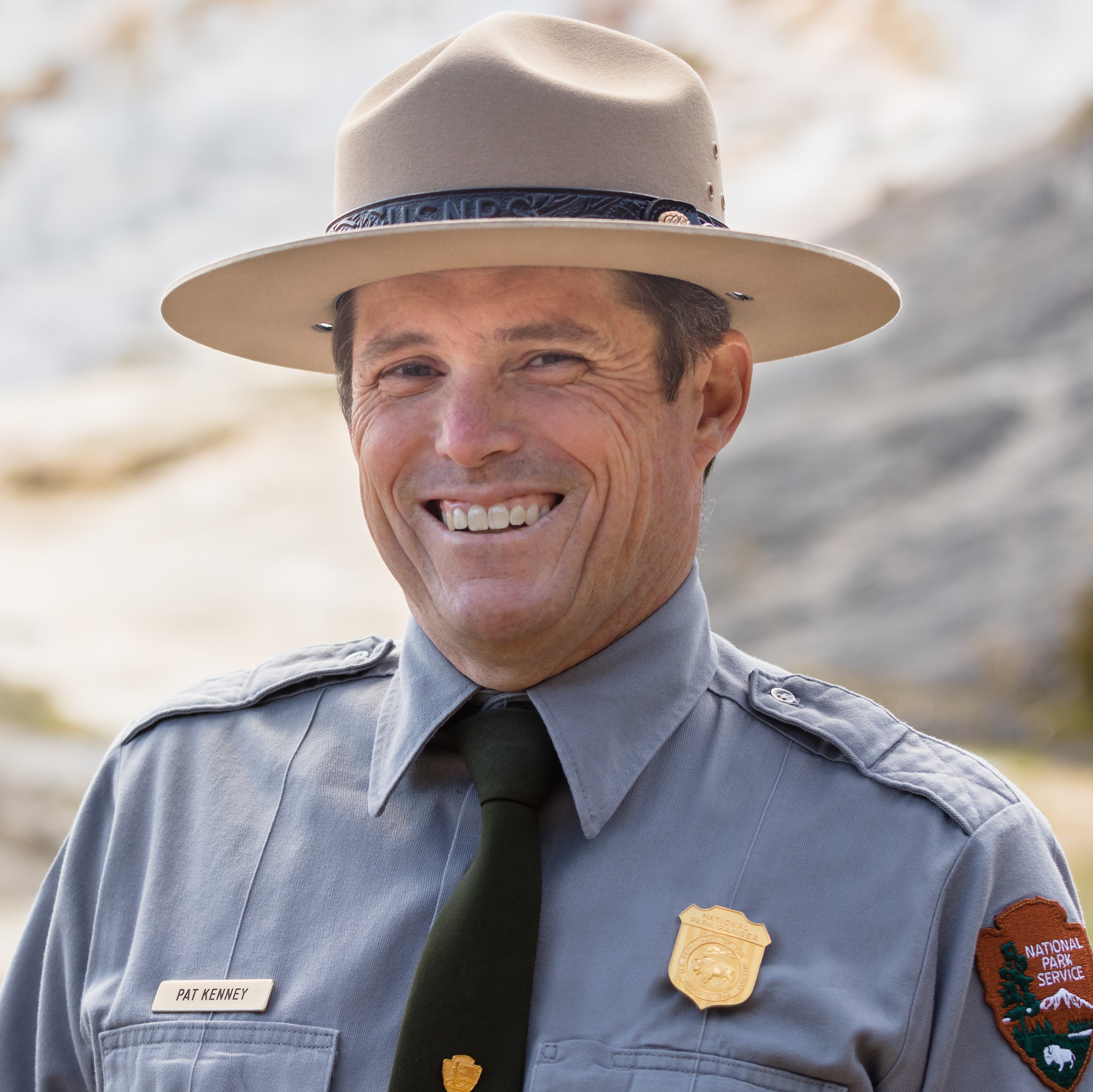 A man in an NPS uniform smiles