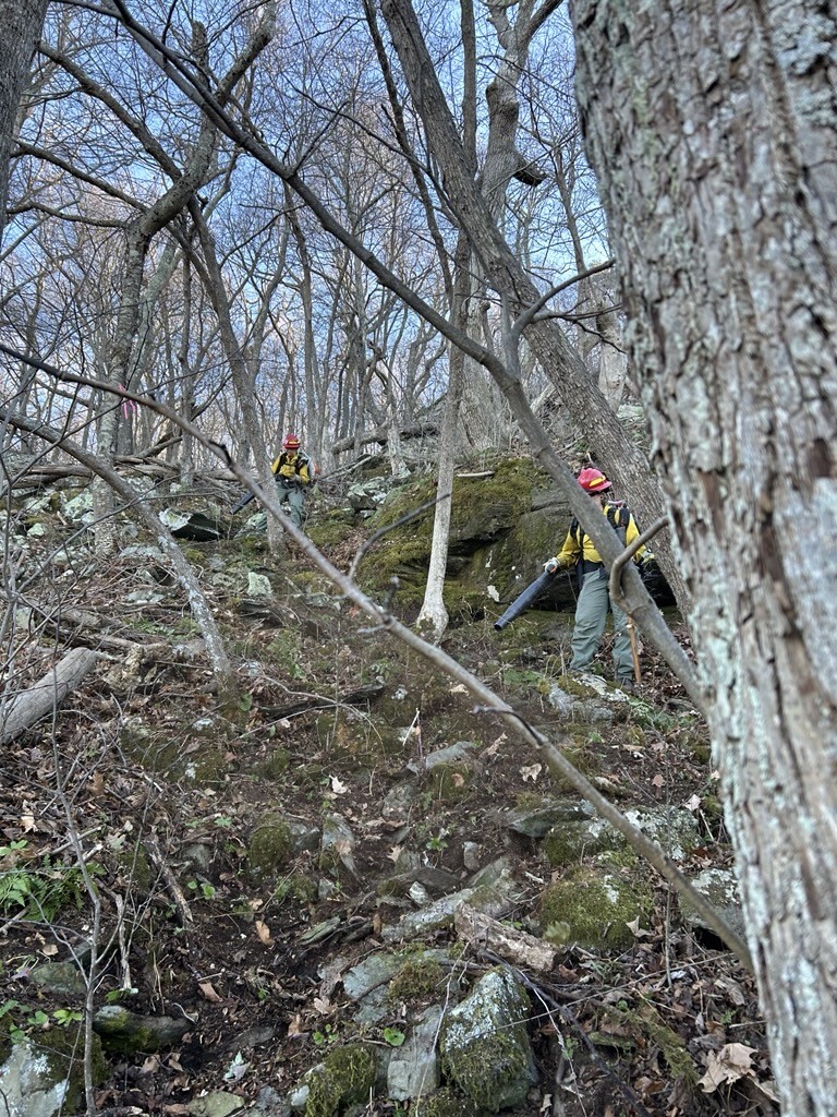 Firefighters on steep rocky terrain