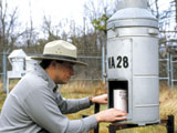 Park staff maintaining air quality monitoring instruments.