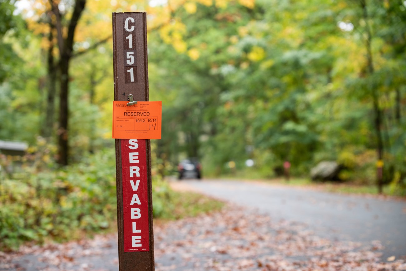 A red post reading "reservable" in white capital letters. An orange reserved notice is clipped to the top.