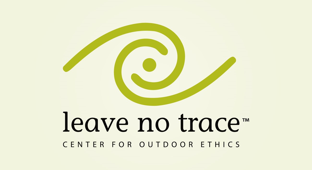 A logo of a green swirl with the words: Leave No Trace Center for Outdoor Ethics