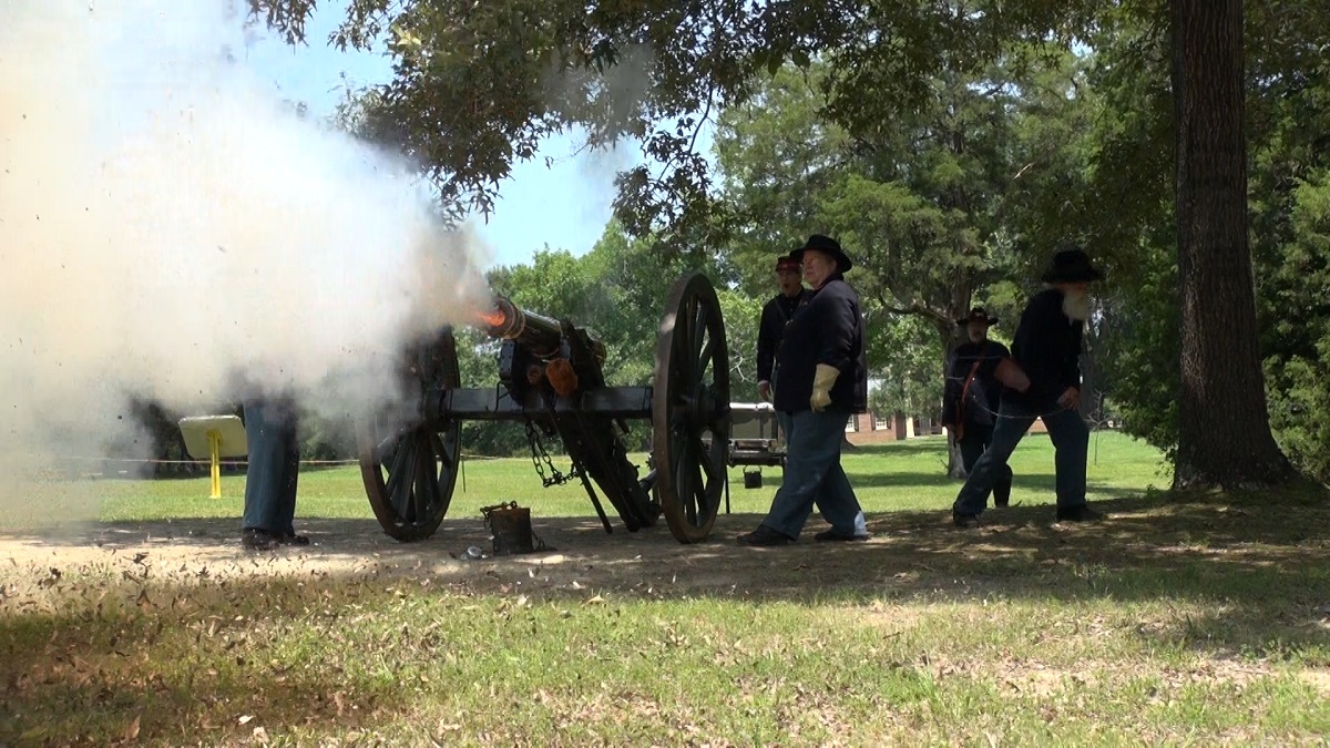 Cannon Fire Front Living historians in blue uniforms fire a cannon
