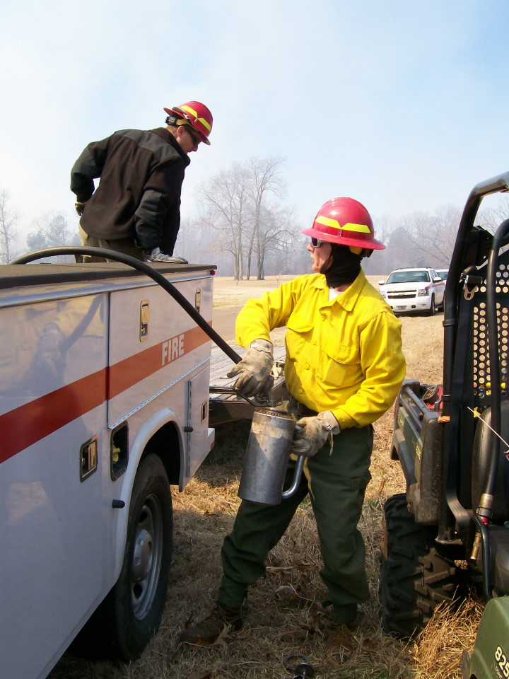 Refill Drip Can Firefighters refill a drip can