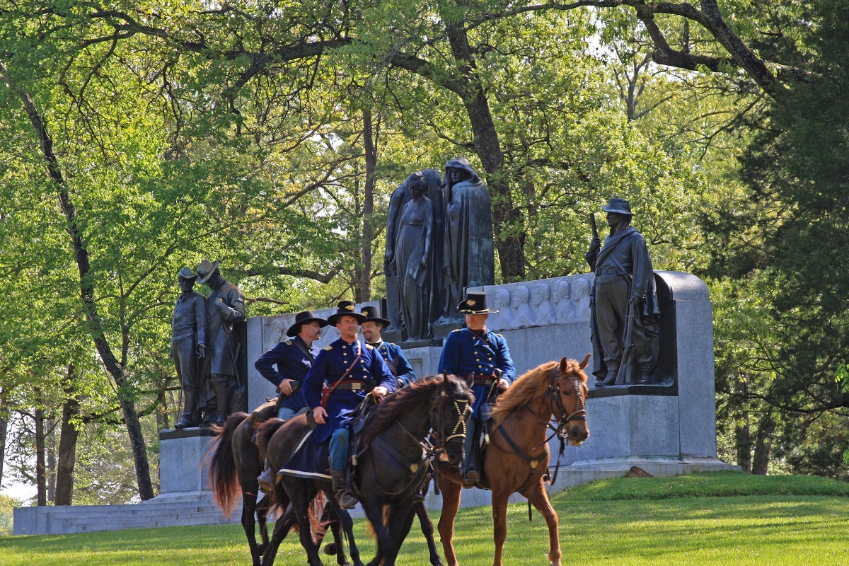federal officers Living historians on horseback ride past the Confederate Memorial