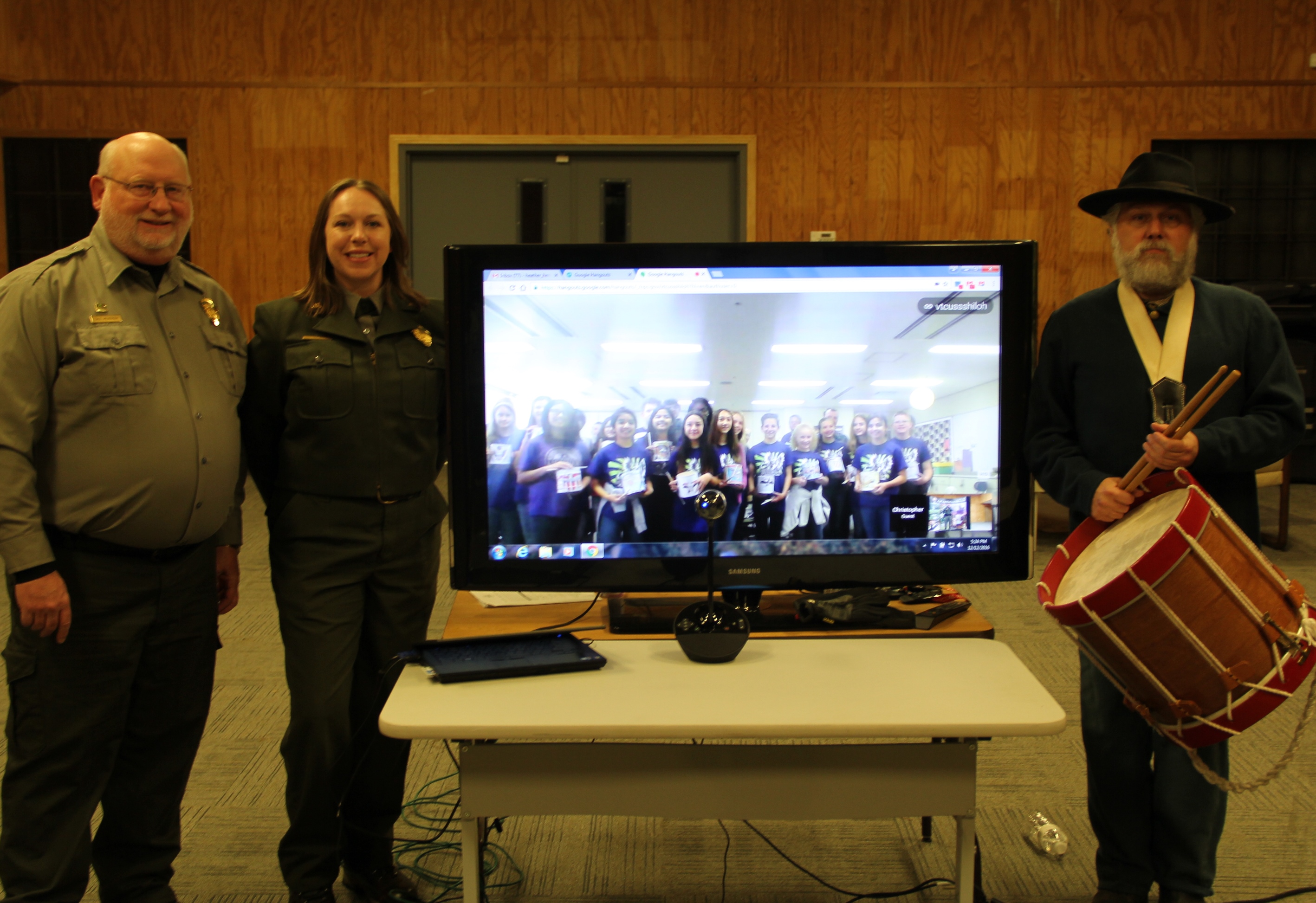 Shiloh Battlefield staff in Tennessee pose with students via TV monitor in Yokosuka, Japan