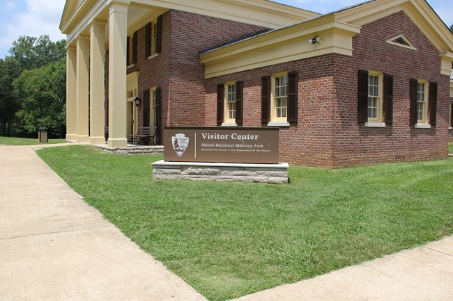 A brick building with yellow columns