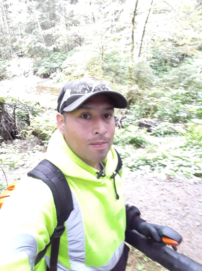 Dose Merculief wearing a ball cap bright yellow jacket