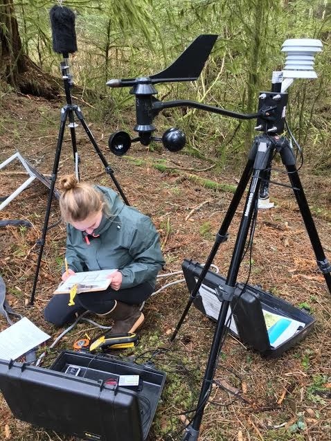 A technician records notes and sets up recording equipment.