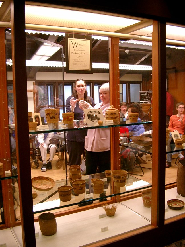 Woven baskets displayed in a glass case
