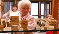 The park's museum curator arranges a display of baskets The park's museum curator arranges a display of baskets
