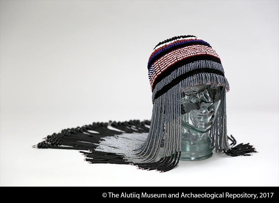 Headdress of red, white, black, blue, and grey beads.