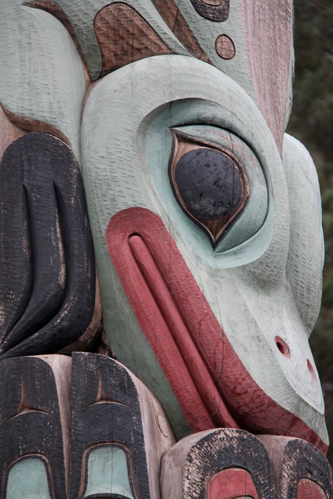 An up close view of a totem pole carving