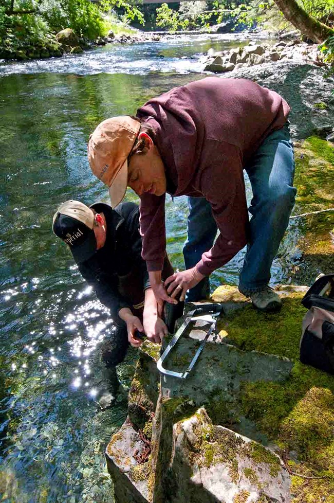 Installing a sonde to collect data on the river.