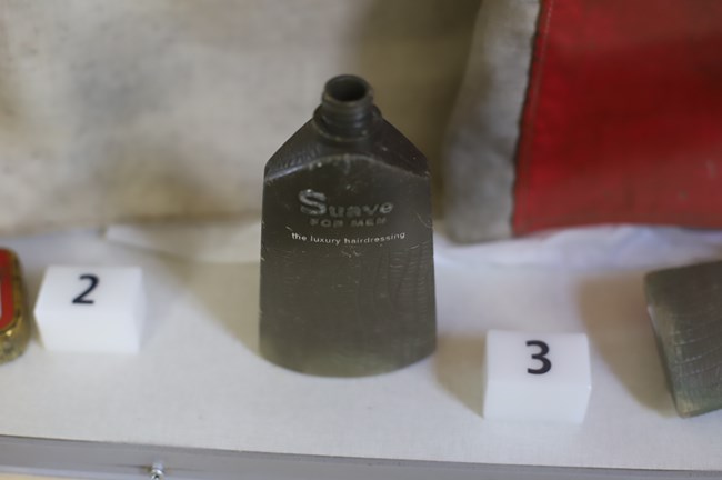 a brown glass bottle with text "Suave for men the luxury hairdressing"
