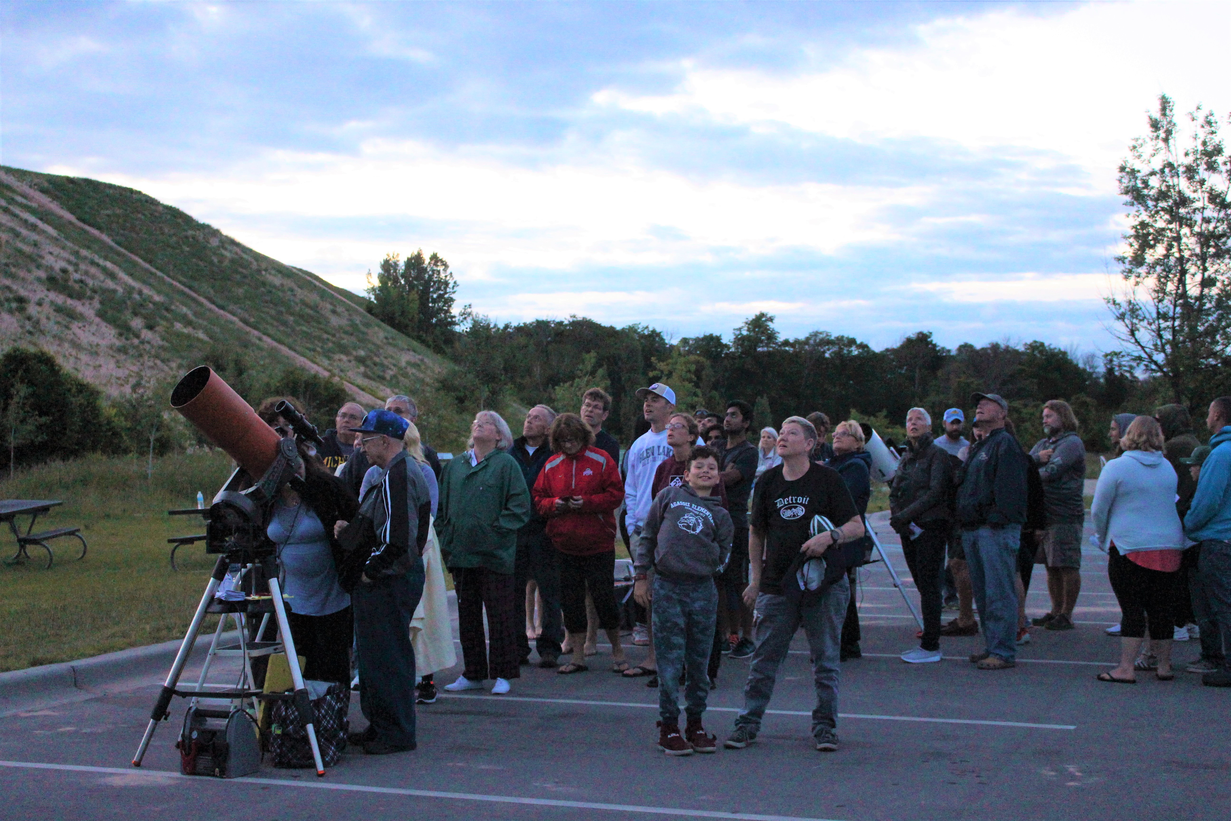 Find-Your-Park-Star-Party-DC-Gazers Visitors surround a large telescope and look up