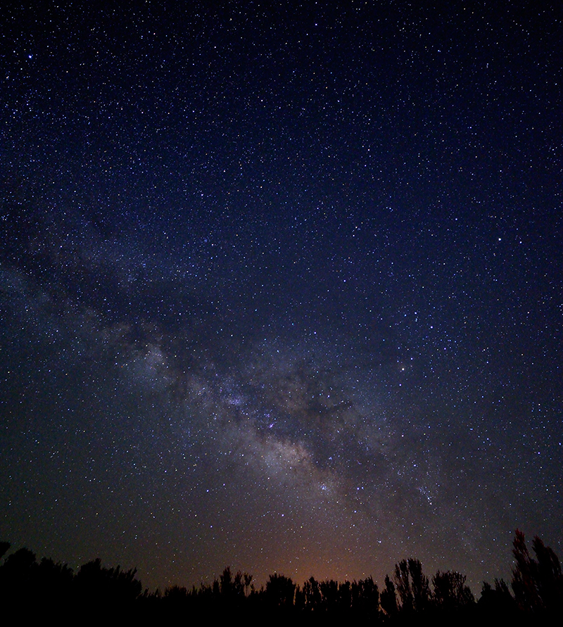 The Milky Way glows in the night sky.