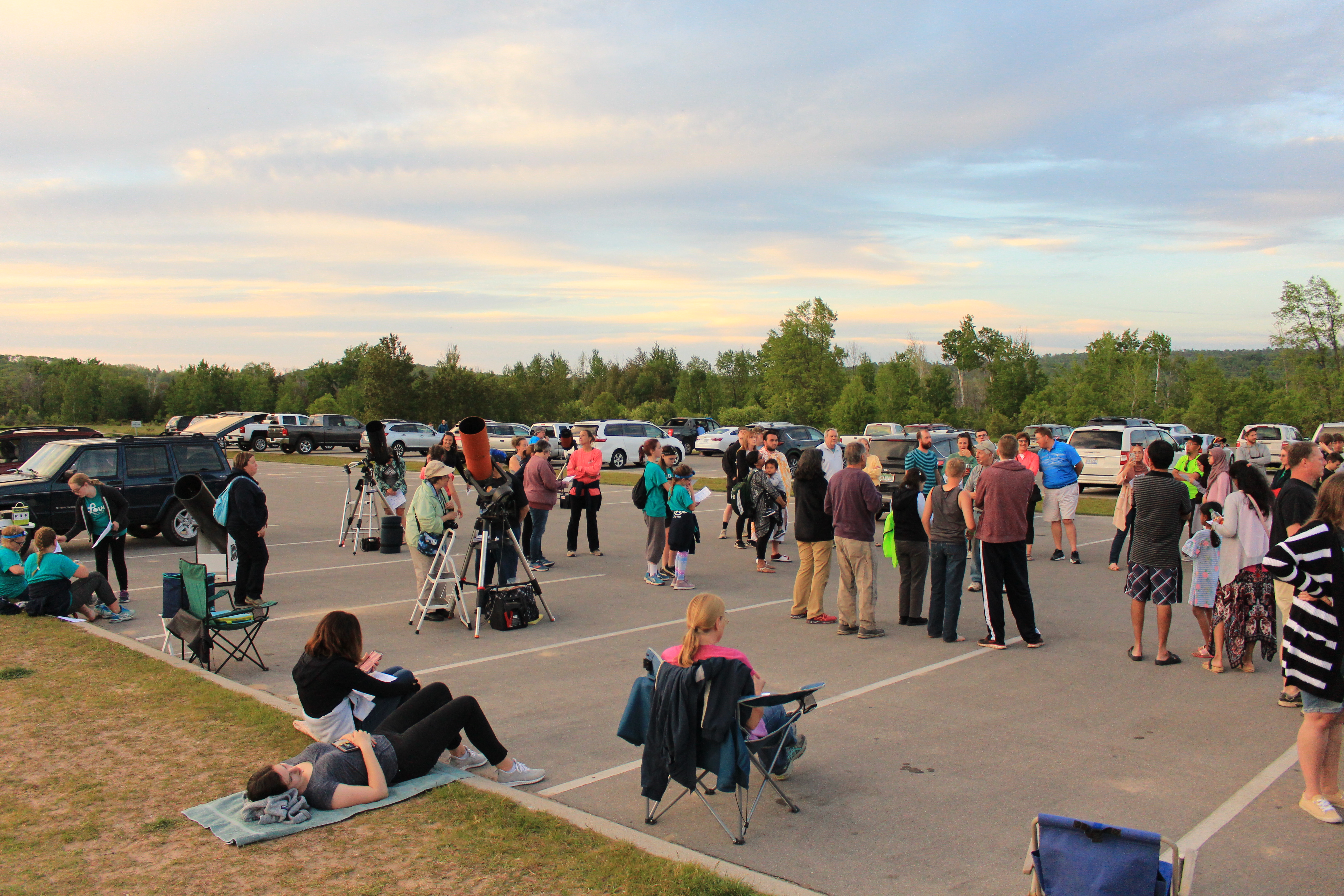 People looking through telescopes at the sun