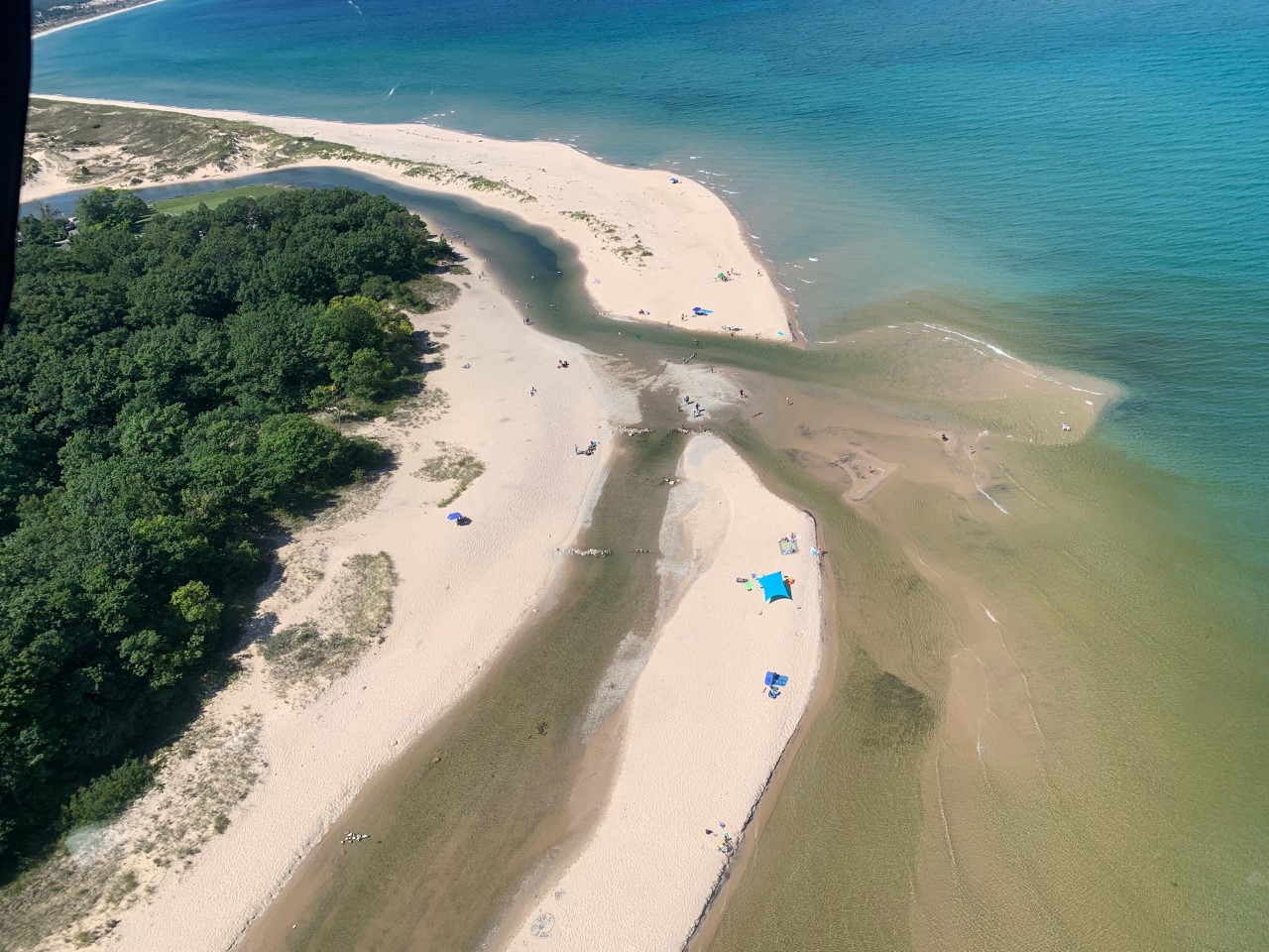 An aerial view of a river splitting into multiple directions. Both feed into a large lake.