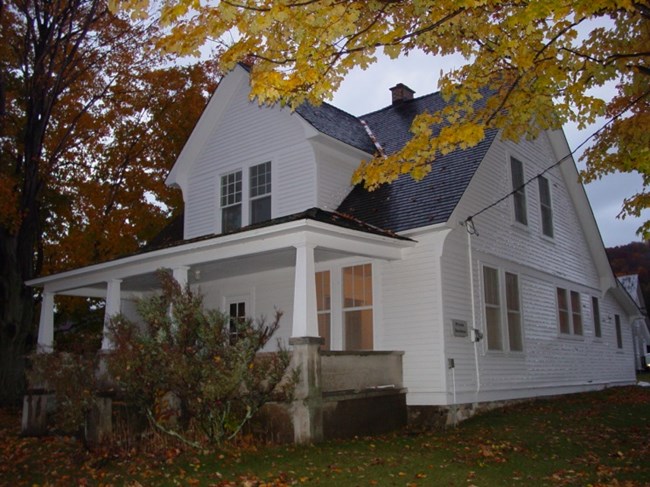 White farmhouse with full porch