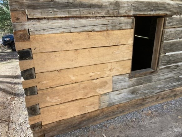 Close up of dove-tailed corners of log cabin