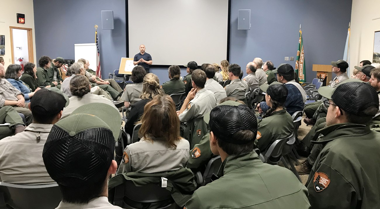 Eric Heminway speaking in front of a room of NPS employees