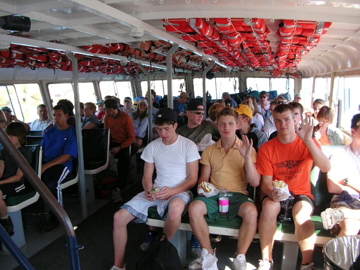 Hikers enjoy the ride inside the ferry to the island