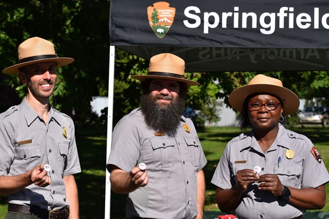 Three park rangers smiling for the camera